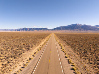 Aerial view of U.S. route 50, the loneliest road in the USA, and of a windmill park in interior...