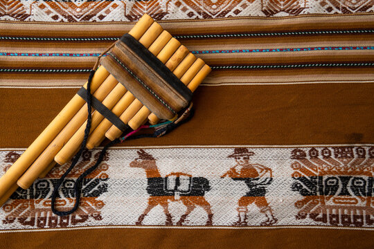 Andean tradition, a zampo&ntilde;a on a traditional Andean weaving from Peru, Bolivia, Ecuador.