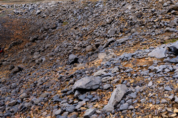 A lakeshore with gray rocks, sedimentation and minerals, hematite rocks, Corani Bolivia