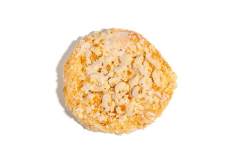 A cookie with a glaze on top. The glaze is a light brown color. The cookie is sitting on a white background Sweet pastries isolated on white background.