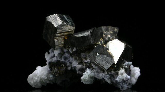 Iron Pyrite crystals (Iron sulfide - "Fools Gold") and quartz crystals rotating slowly against a black background [Bulgaria]