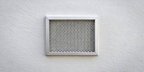 A square vent with a diamond-shaped wire mesh grid, framed in a sleek silver trim, set against a backdrop of a white textured wall.