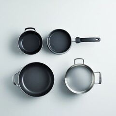 A collection of cooking pots and pans arranged neatly on a light background.