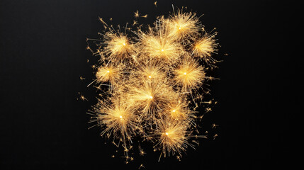 A cluster of multiple bright golden sparklers sparkling against a dark background, creating an intricate pattern of light rays and particles.