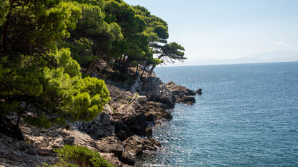 Seaside with cliffs and azure sea, Dalmatian region, Makarska Riviera, Croatia.