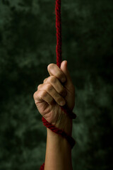 pulling a red rope symbolizing the struggle against aids