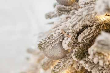 A Christmas tree sprinkled with artificial snow in the New Year's interior. Background for New Year...