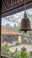 Fototapeta premium A handcrafted temple bell hangs in a serene courtyard of a Buddhist temple