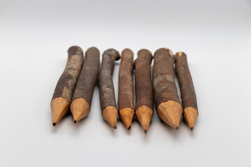 Rustic Wooden Pencils with Natural Bark Finish Aligned in a Row for a Raw and Organic Aesthetic