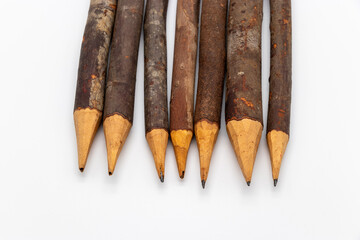 Close-Up of Rustic Wooden Pencils Aligned in a Neat Row with Natural Bark Finish