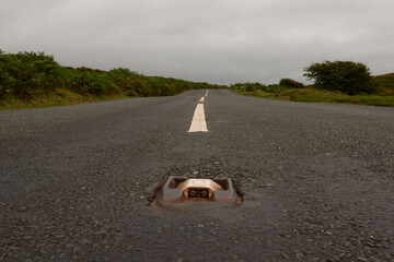 Road to Solitude – A quiet country road vanishes into the unknown, beckoning wanderers to follow...