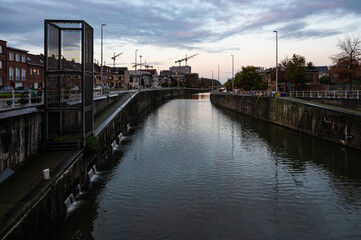 Sluice constructions during rainy sunset iat the canal in Anderlecht, Brussels Capital Region, Belgium