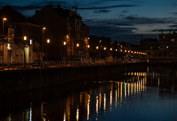 Fototapeta premium City night reflections and metal Vierendeel bridge in Anderlecht, Brussels Capital Region, Belgium