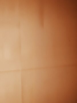 Plain brown wall texture with subtle nuances in light and shadow