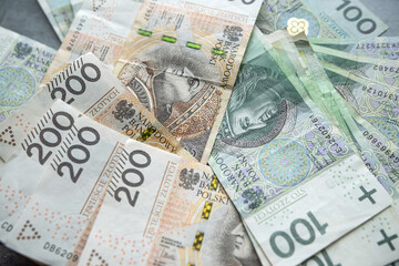 pile of PLN 100 and 200 zloty bills finance background. Saving concept