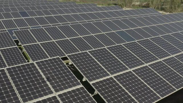 aerial 4k drone view of photovoltaic solar panel energy technology field