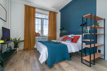 Obraz premium Modern bedroom interior. Light decor with bright colorful elements. A wide bed with .colorful pillows.