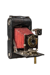 old 20th century photo camera with retractable lens on light background