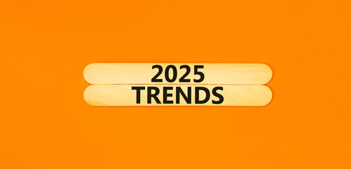 Planning 2025 trends new year symbol. Concept words 2025 Trends on beautiful wooden sticks. Beautiful orange background. Business 2025 trends new year concept. Copy space.