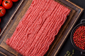 Raw ground beef or pork with salt, spices, herbs and tomatoes