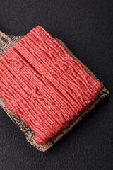 Raw ground beef or pork with salt, spices, herbs and tomatoes