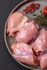 Fresh raw chicken thigh fillets with salt, spices and herbs