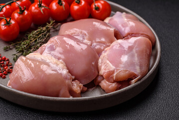 Fresh raw chicken thigh fillets with salt, spices and herbs