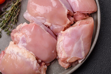 Fresh raw chicken thigh fillets with salt, spices and herbs