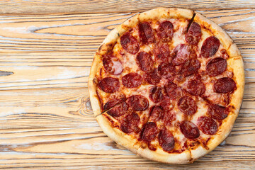 Pizza pepperoni fast food . Top view on rustic background