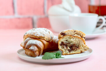 Breakfast with tea and croissant cookies or crookie.