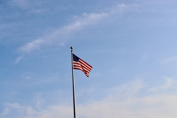The United States flag blowing in the wind.