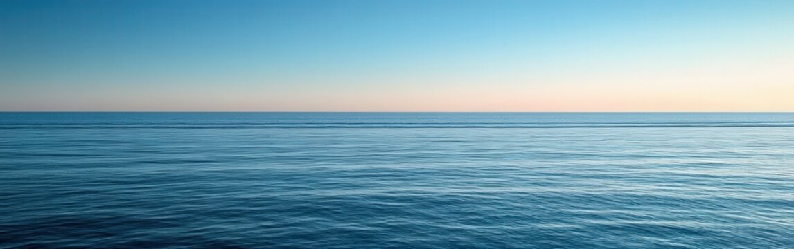 Calm ocean horizon at dusk with gentle waves and clear sky