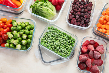 Boxes with fresh raw vegetables on table.