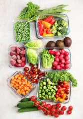 Boxes with fresh raw vegetables on table.
