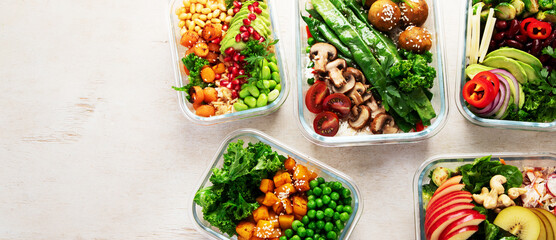 Glass containers with fresh vegan food, ready for meal prepping.