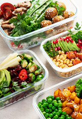 Glass containers with fresh vegan food, ready for meal prepping.