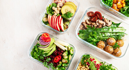 Glass containers with fresh vegan food, ready for meal prepping.