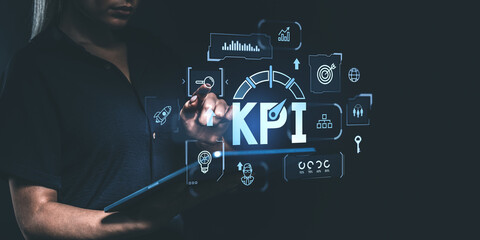 Businesswoman interacting with KPI dashboard on a digital screen