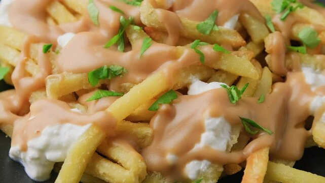 Delicious traditional canadian dish poutine gravy and fries with cheese. Rotating video