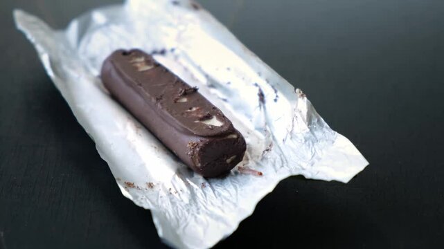 Worms crawls on chocolate candy. Crawling larvae and eggs laid on food. Not fresh spoiled product. A disgusting sight. Sickening and disgusting. Violation of storage conditions in a grocery store. 4K