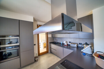 A modern kitchen with the hood in the foreground