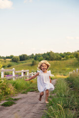 A child runs across a field in a village. Selective focus.