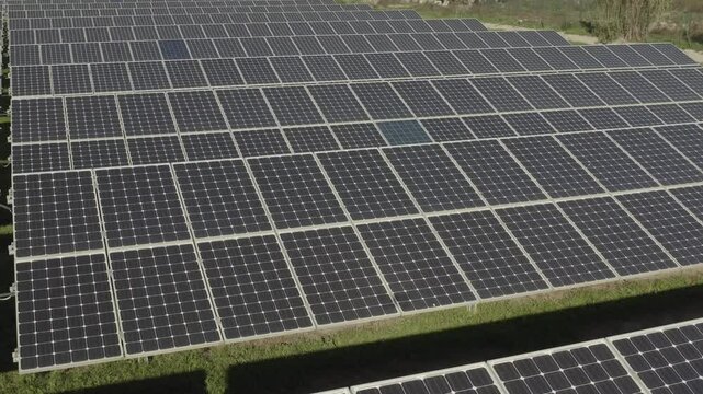 aerial 4k drone view of photovoltaic solar panel energy technology field