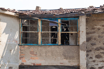 Broken window in a dilapidated and abandoned house.