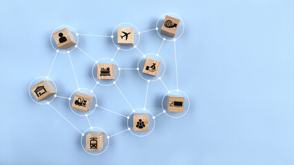 Top view wooden block on blue background with logistic icon. Linked with each other with lines as distribution channels. Concept of logistics, delivery or global cargo