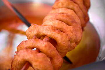 Peruvian picarones are a traditional dessert commonly found in Peru. They are a type of doughnut made from a sweet potato and pumpkin batter, which is deep-fried until golden brown