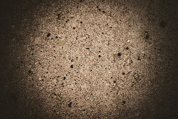 close-up of brown gray concrete wall background with porous hole texture grunge backdrop and vignette border
