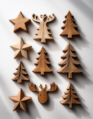 Wooden ornaments in the shape of Christmas trees, reindeer, and stars, arranged on a plain white surface