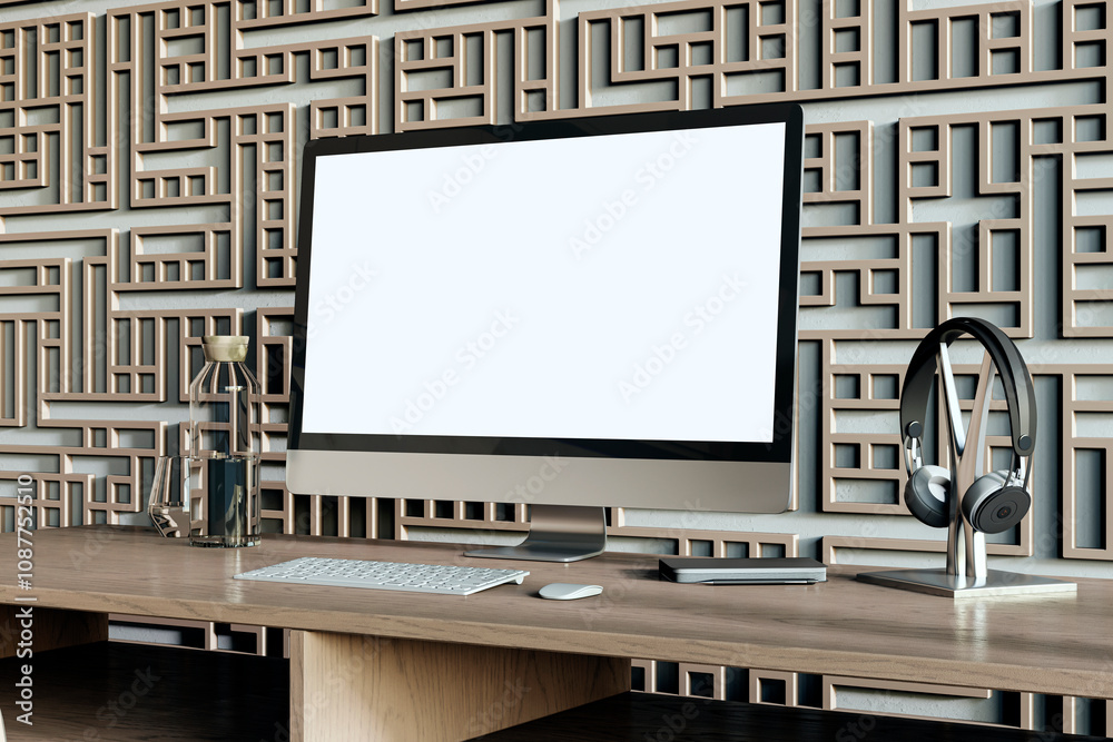 Poster Modern designer workplace with decorative ornamental wall, various small items and big white computer monitor with mock up place. 3D Rendering.