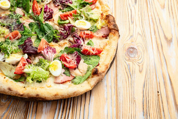 Italian pizza caesar with eggs salad chicken tomatoes and mozzarella photography. top view